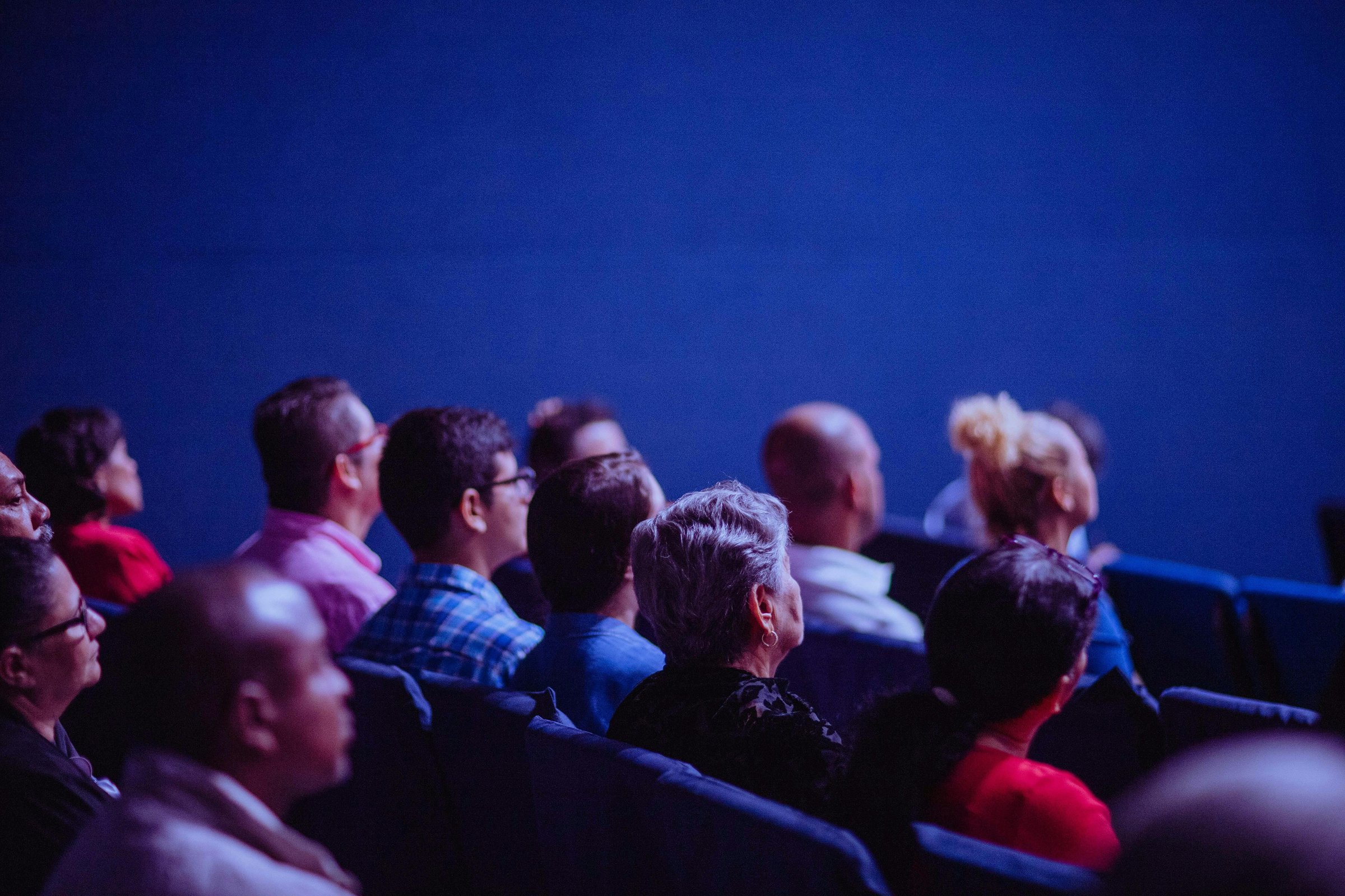 group of people on the side, looking at the stage