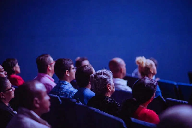 group of people on the side, looking at the stage