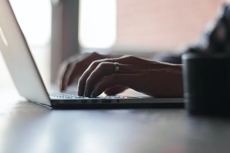 person typing on laptop keyboard