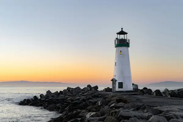 lighthouse with sea in the background